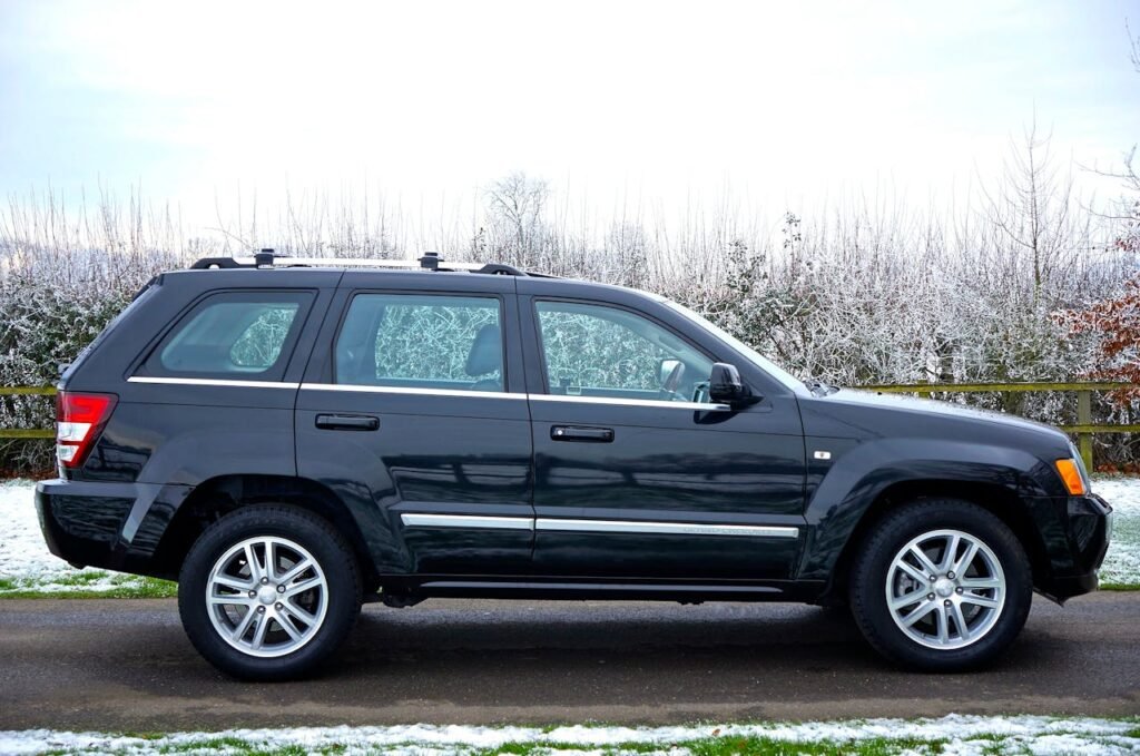 pexels-photo-104404 A black SUV parked outdoors on a snowy road surrounded by a winter landscape.
