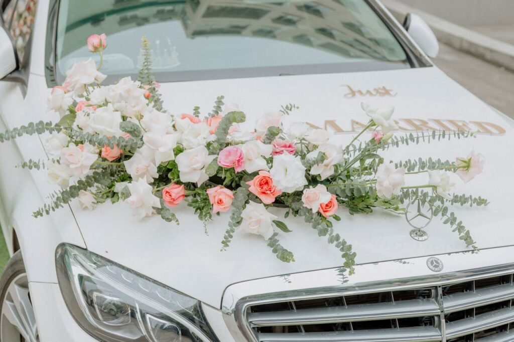 Close-up of a wedding car adorned with beautiful flower arrangements.